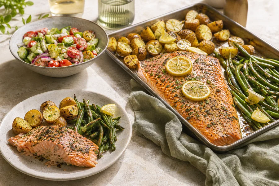Sheet-pan salmon with potatoes and green beans beside a chopped salad